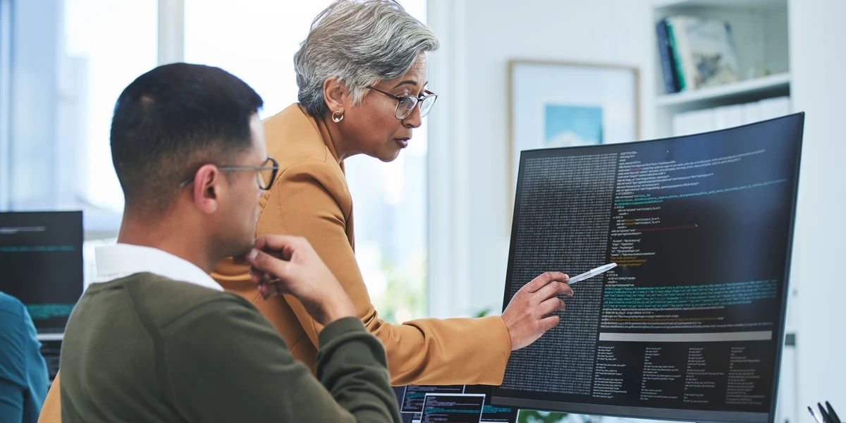 Women point to computer analyzing data